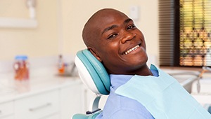 Man smiles after getting dental implants in Phoenix