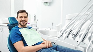 Male dental patient sitting back and smiling