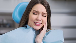 Woman holding face in pain