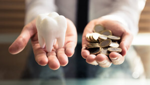 coins next to a tooth