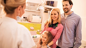 Family smiling in dental office