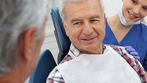 Smiling senior man in dental chair