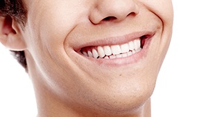 Closeup of young man with whole healthy teeth