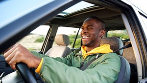 Man smiles while driving