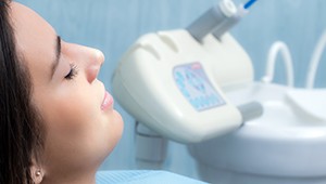 Woman in dental chair with eyes closed