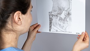 Dentist looking at diagram of human skull