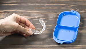 Hand holding occlusal splint for TMJ disorder
