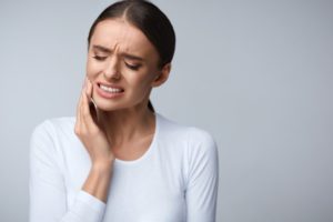 A woman experiencing dental pain. 