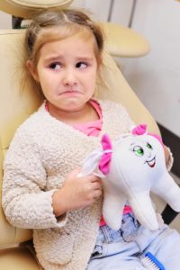 unhappy girl at dentist