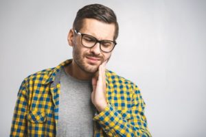 Man experiencing dental pain. 