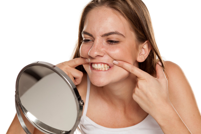 Patient checking their teeth whitening progress in mirror