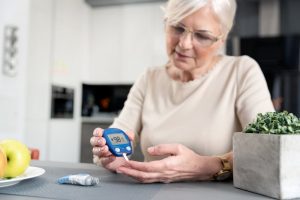 woman with diabetes checking her blood glucose levels