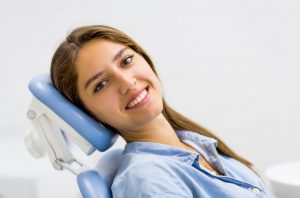 Happy patient at appointment to use dental benefits in Phoenix