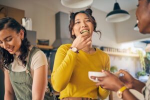 Woman eating food with friends