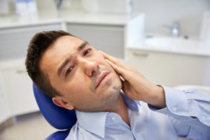 Man experiencing dental pain. 