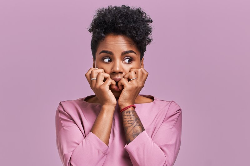 Closeup of woman with fear of tooth extractions 